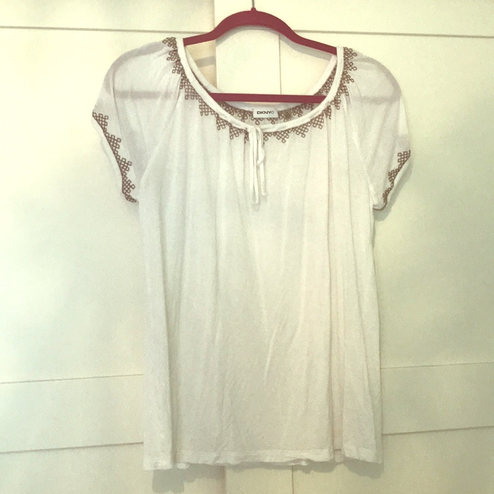 Women’s scoop neck white blouse with embroidery.